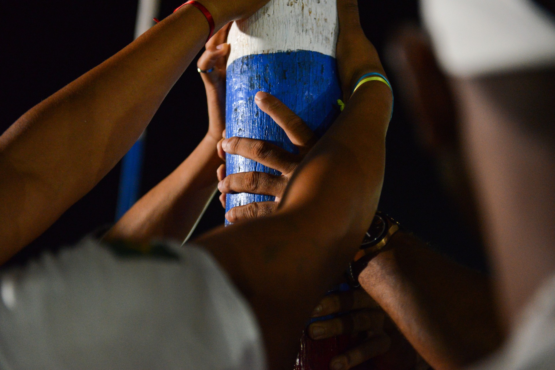 Pilgrims holding a pole during a religious celebration in the Bolivian Amazon